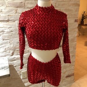 Red sequence shorts and long sleeve costume.